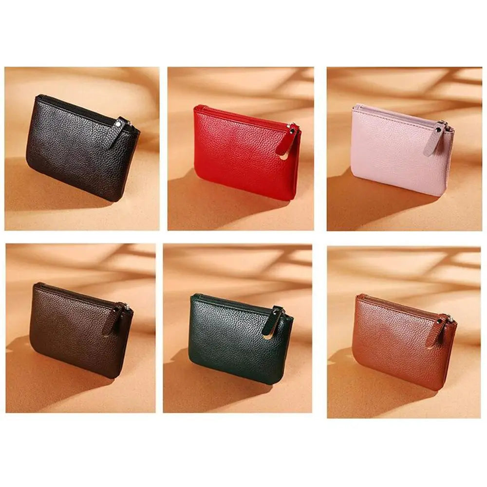 Six small leather coin purses in black, red, pink, brown, green, and tan colors.