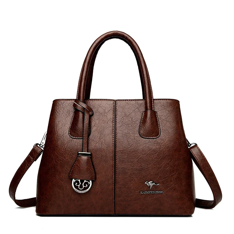 Brown leather handbag with dual handles and a detachable shoulder strap.