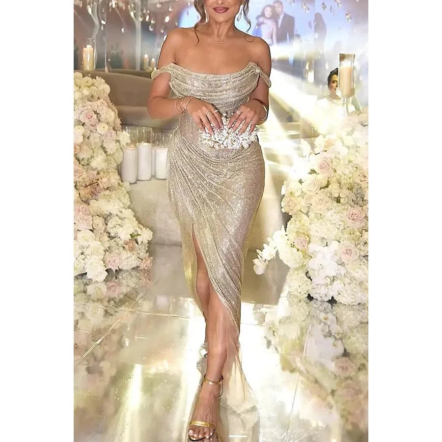 Elegant gold sequin dress with high slit, worn at a formal event.