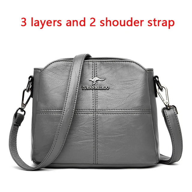 Gray shoulder bag with 3 layers and two adjustable straps.