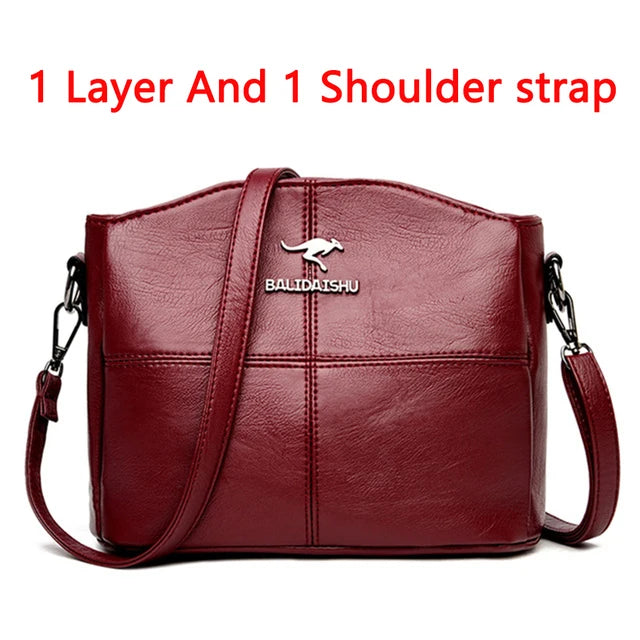 Red leather shoulder bag with one layer and a single strap.