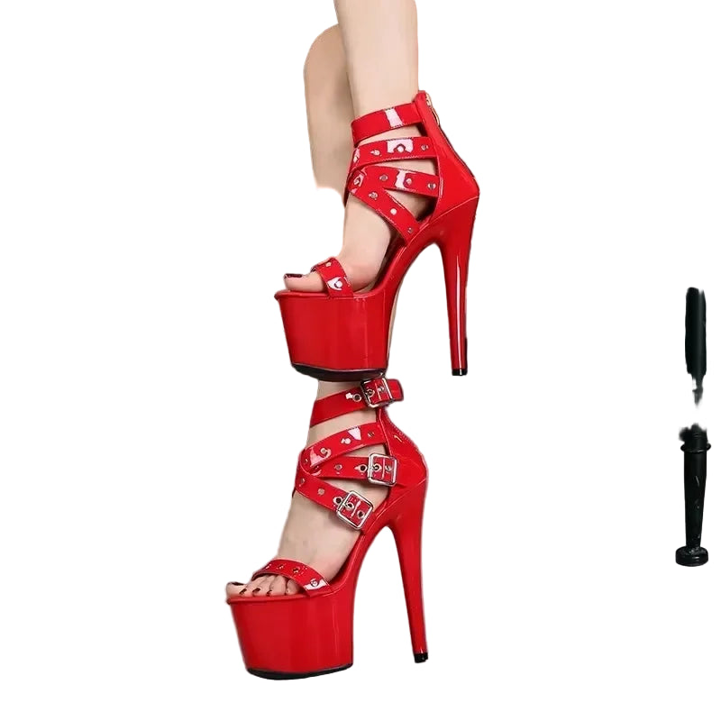 Red high-heeled platform sandals with heart buckles.