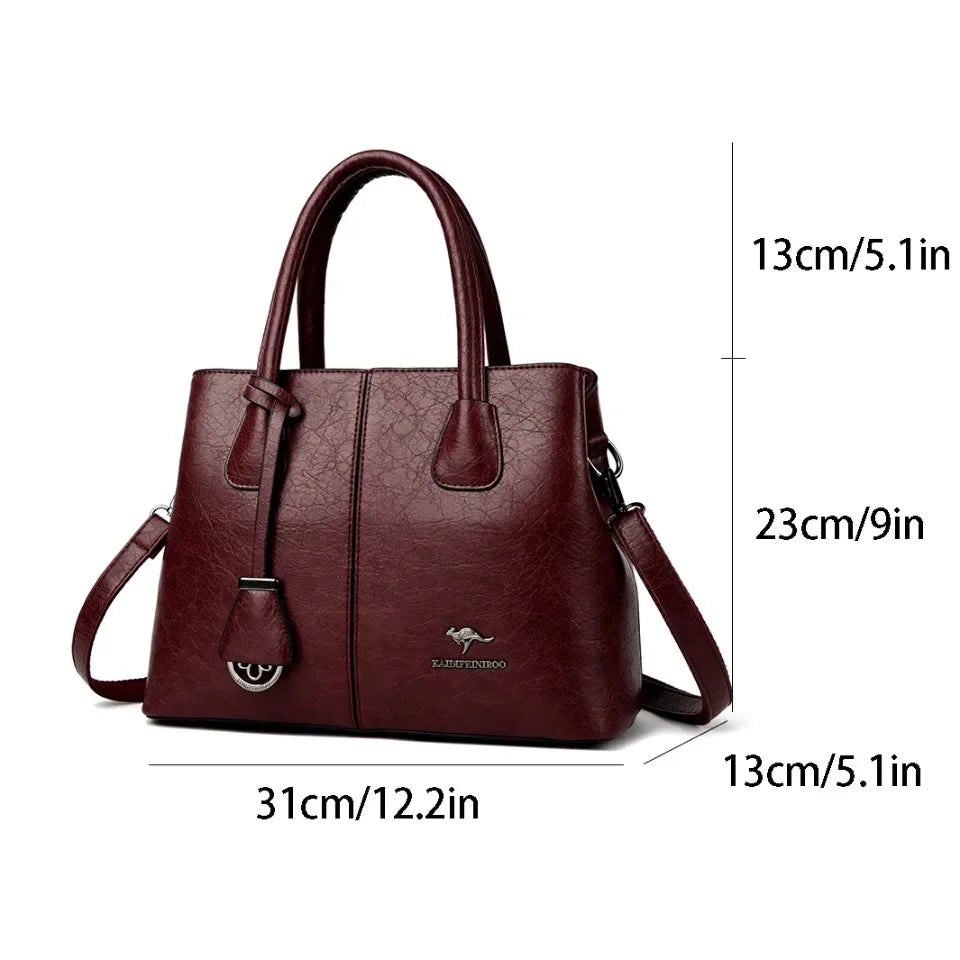 Wine-colored leather tote bag with dual handles and dimensions labeled.
