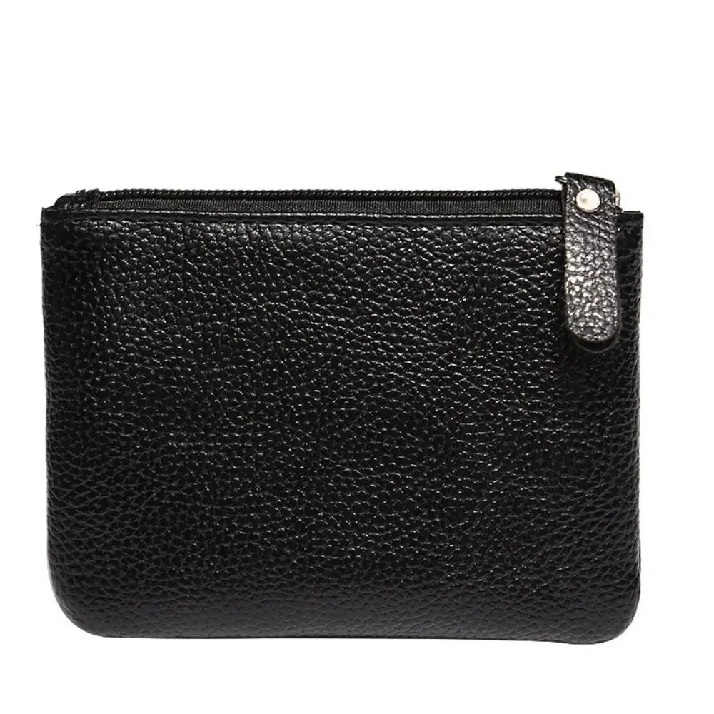 Black textured leather wallet with zip closure and small tag on the side.