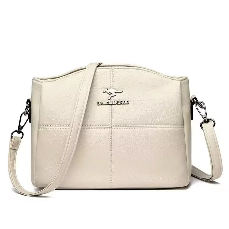 White womens shoulder bag with kangaroo logo and adjustable strap.