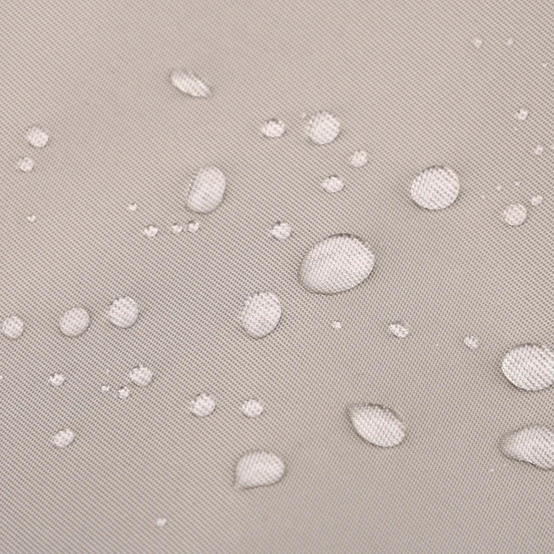 Water droplets on a textured, light-colored fabric surface.